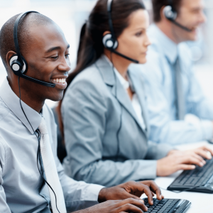 Diverse team of professionals in a UK call centre, wearing hands-free headsets.